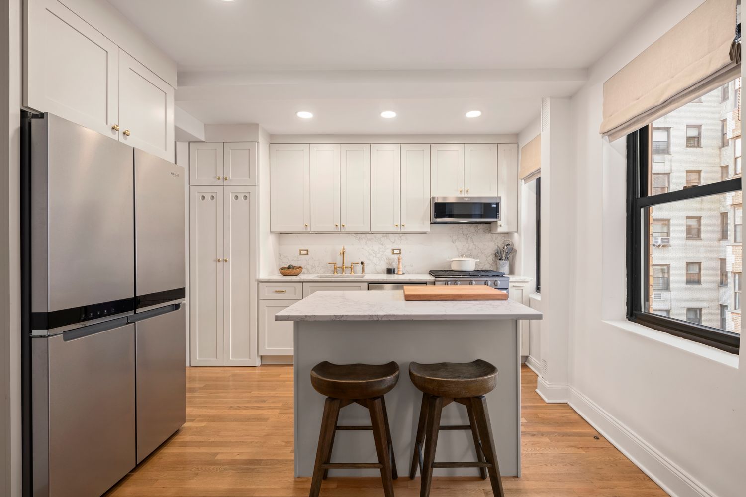 a kitchen with refrigerator cabinets and wooden floor