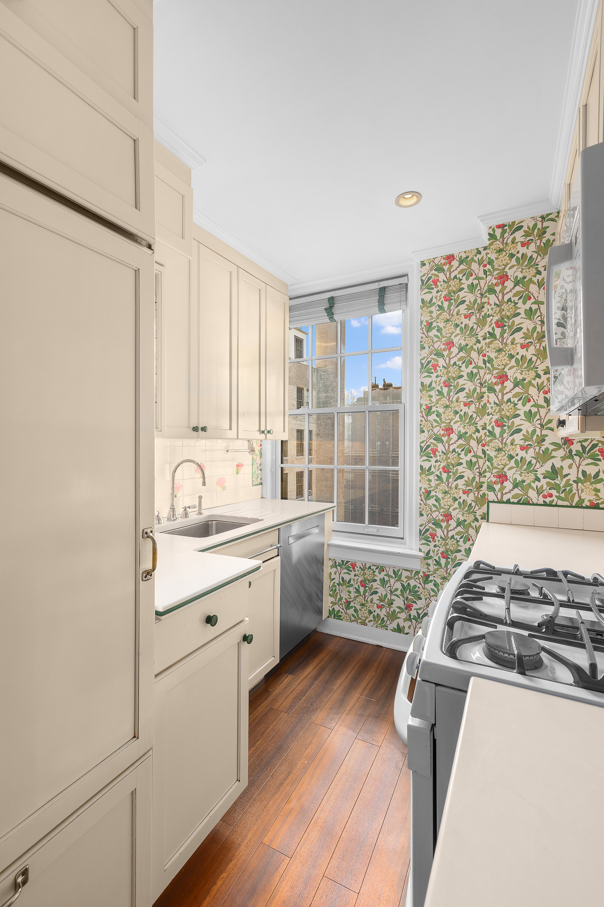 1088 Park Avenue, Unit 15C Manhattan, NY 10128 - Photo 14 of 26 a kitchen with a stove a sink and a refrigerator