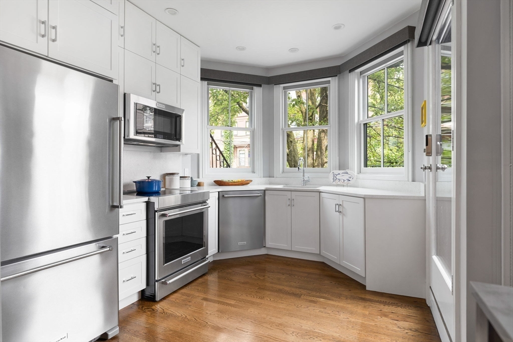 135 West Concord Street, Unit 1 Boston, MA 02118 - Photo 13 of 36 a kitchen with a white cabinets and a refrigerator