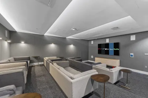 a living room with furniture a lamp and large window