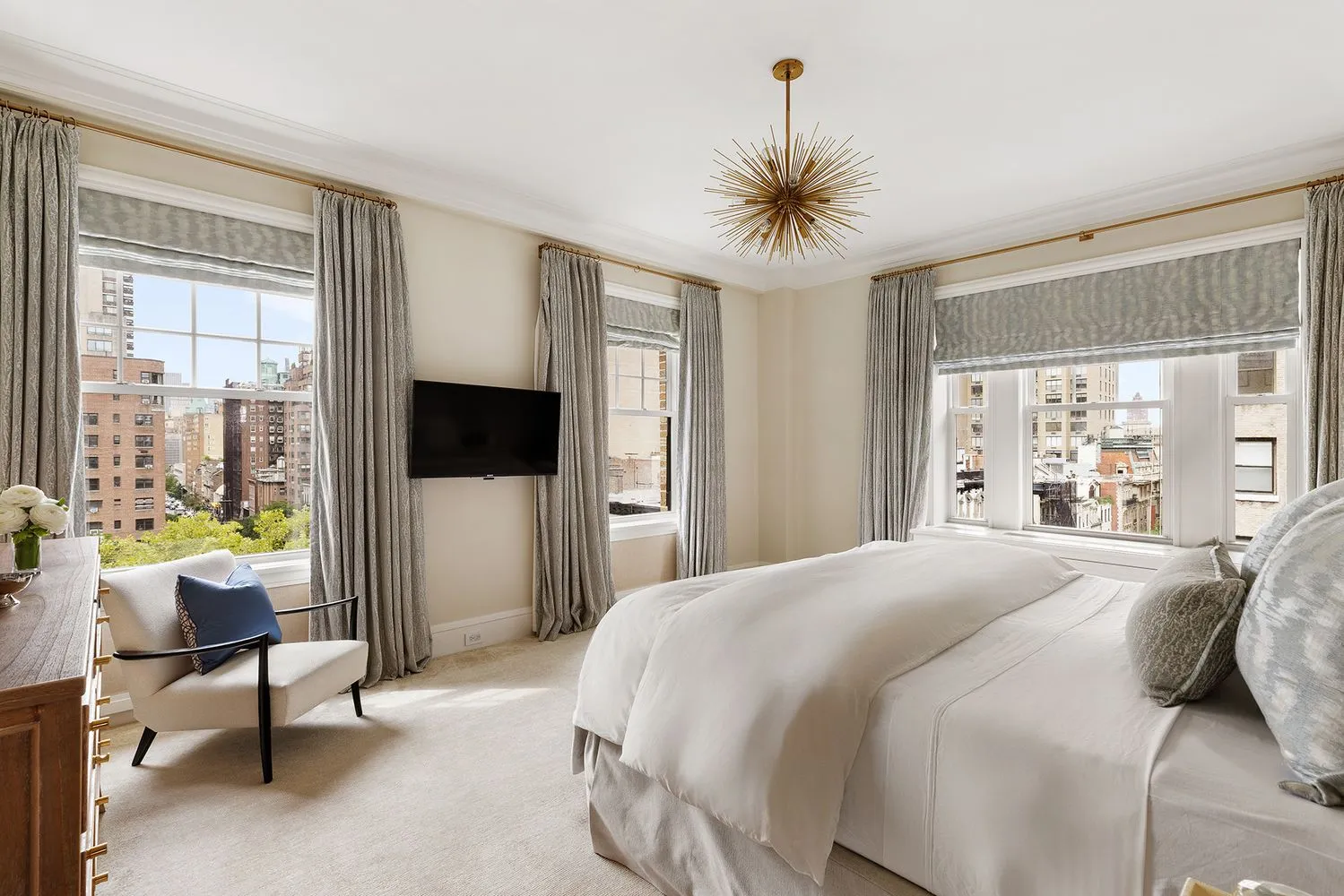 a bedroom with a large bed and a flat screen tv