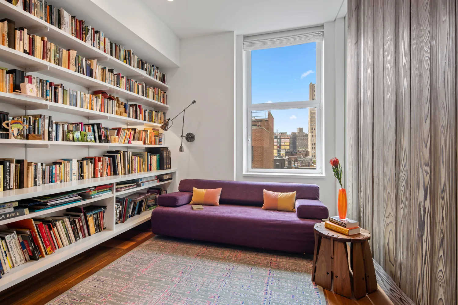 a living room with furniture and a book shelf