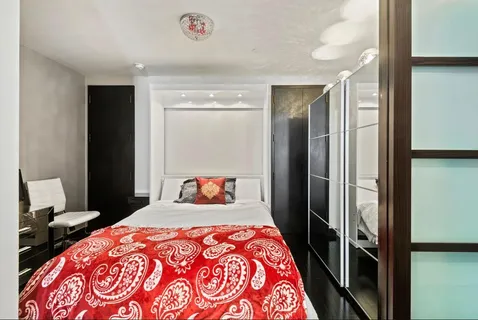 a bedroom with a bed and a dresser