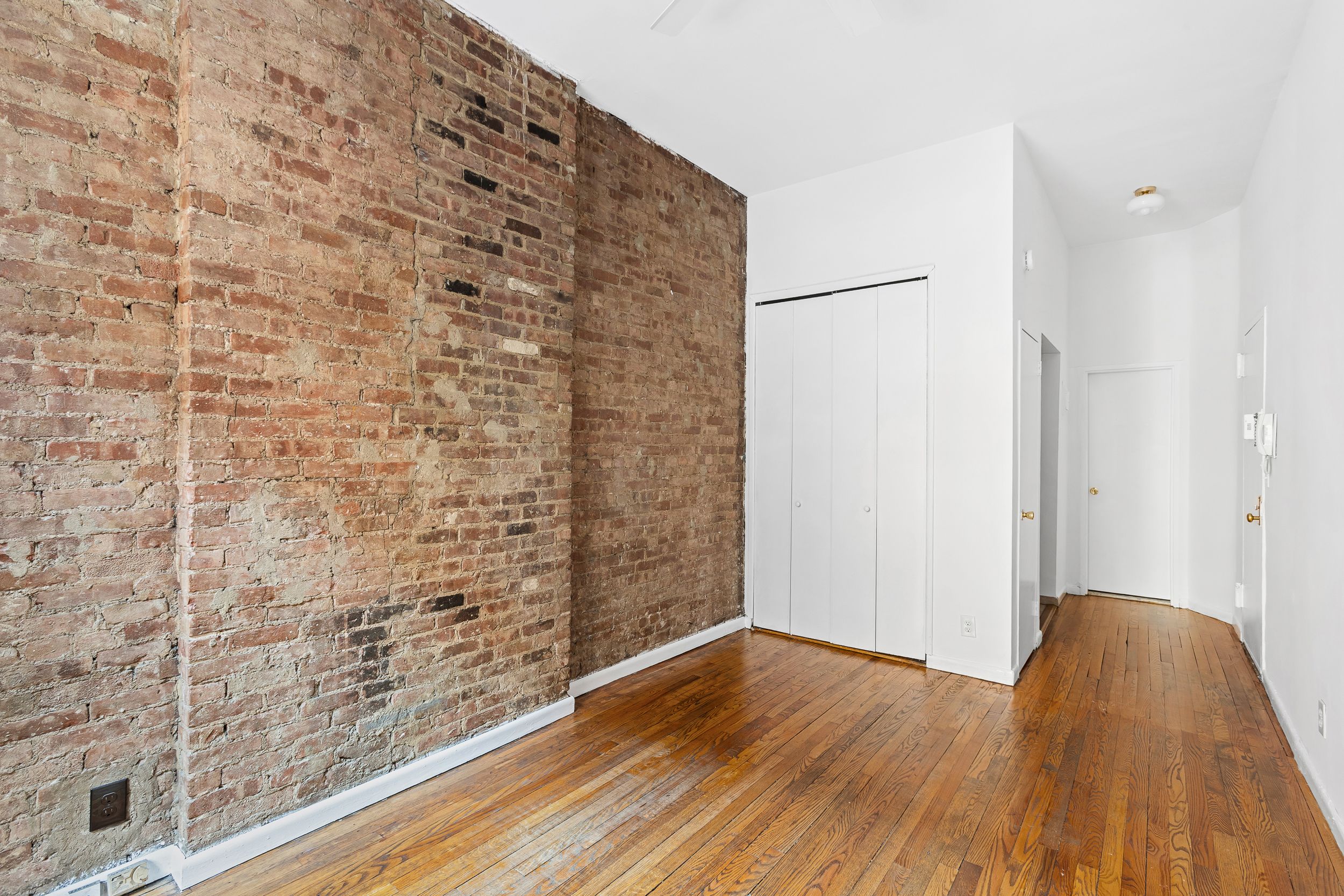 529 East 88th Street, Unit 1B Manhattan, NY 10128 - Photo 3 of 7 a view of a bathroom with wooden floor and a sink