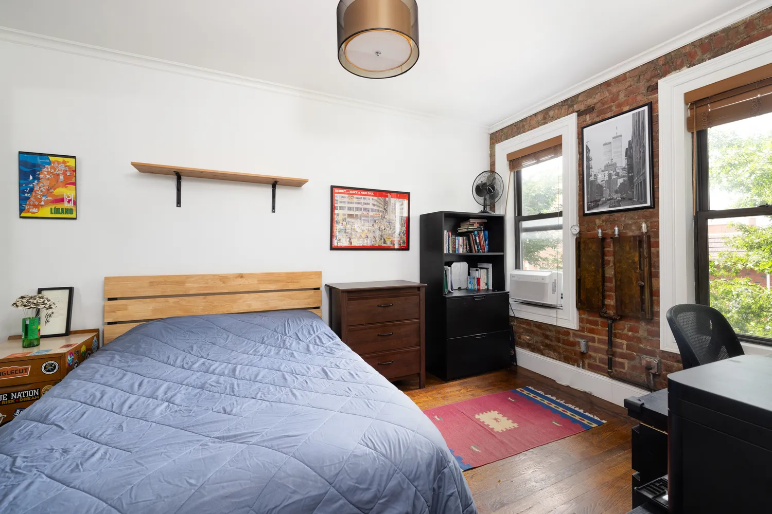 a bedroom with a bed and a dresser next to a window