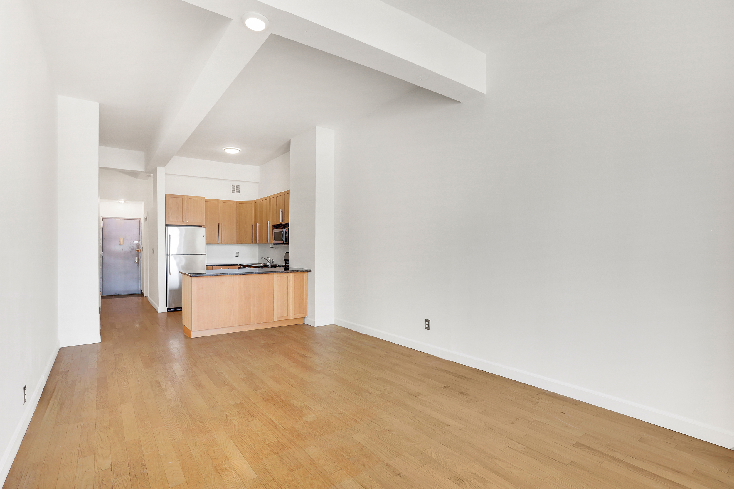 315 7th Avenue, Unit 10E Manhattan, NY 10001 - Photo 8 of 13 a view of kitchen with refrigerator and window