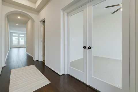 a room with wooden floor and entryway