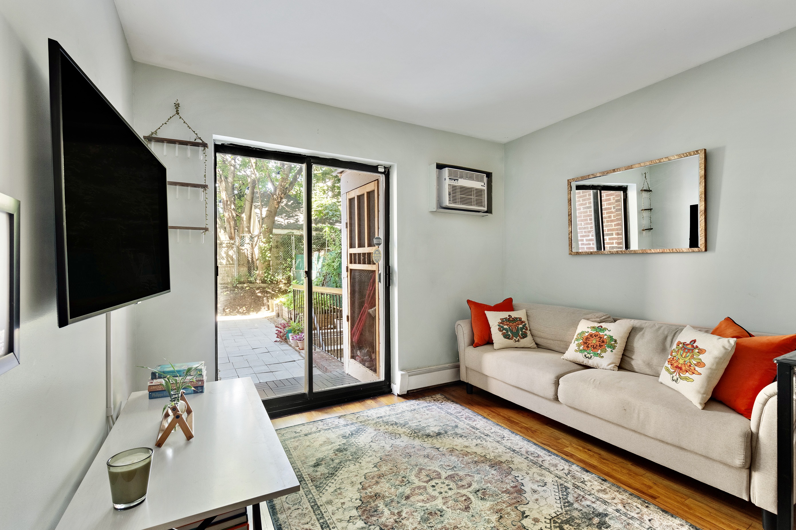 105-09 Otis Avenue, Unit 1B Queens, NY 11368 - Photo 5 of 9 a living room with furniture and a flat screen tv