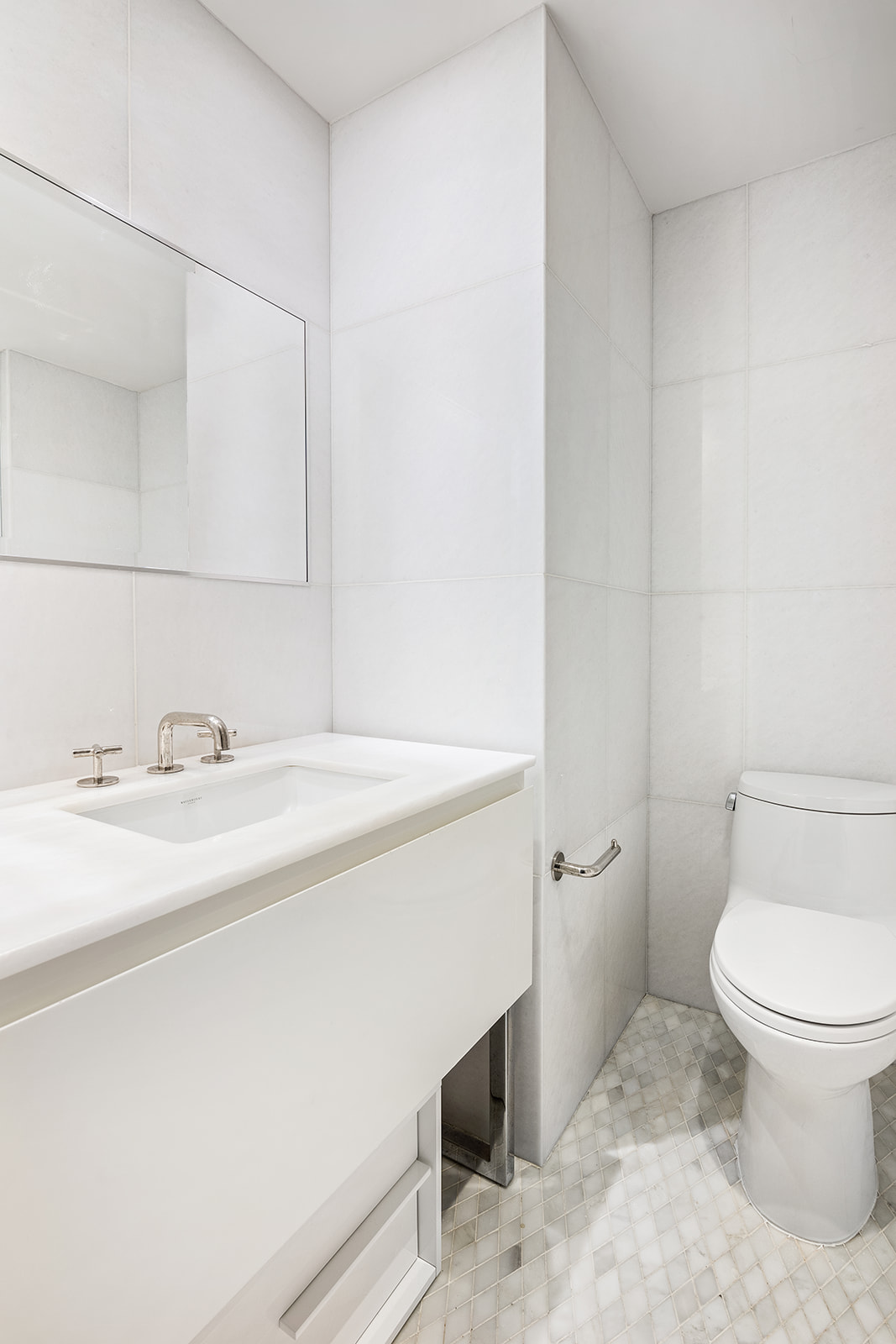 5 Franklin Place, Unit 14B Manhattan, NY 10013 - Photo 5 of 13 a bathroom with a sink a toilet and a mirror