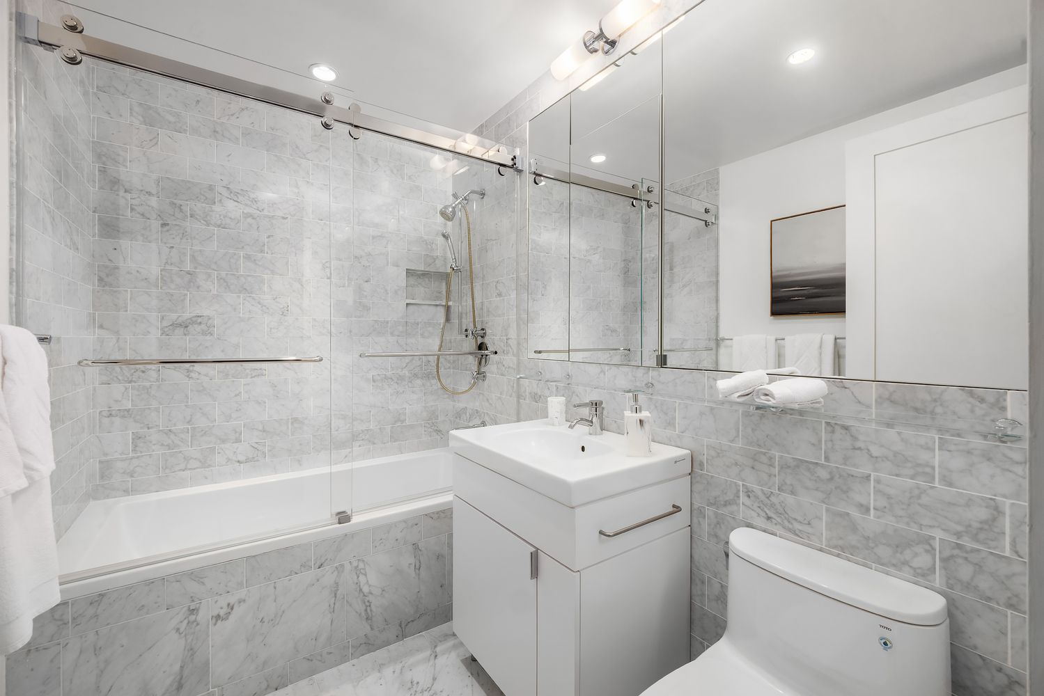 a bathroom with a sink toilet and shower