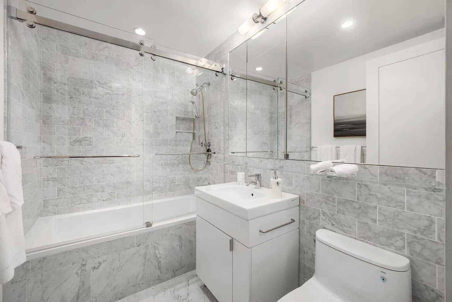 a bathroom with a sink toilet and shower