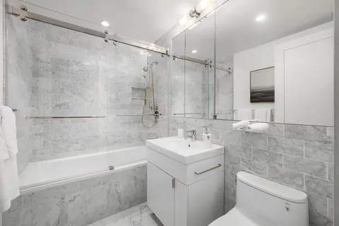 a bathroom with a sink toilet and shower