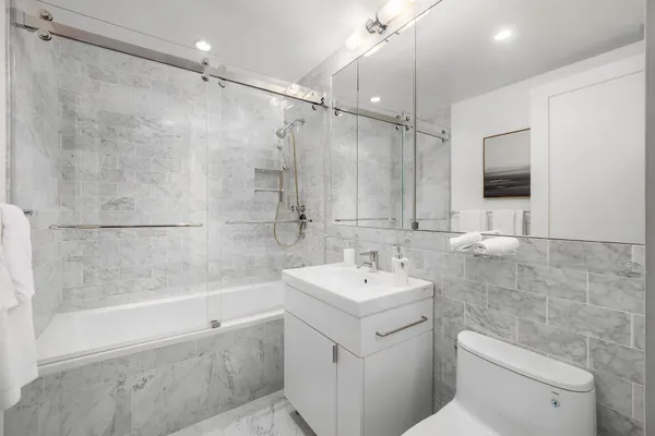 a bathroom with a sink toilet and shower