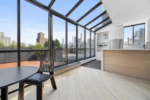 a view of a room with furniture and floor to ceiling window