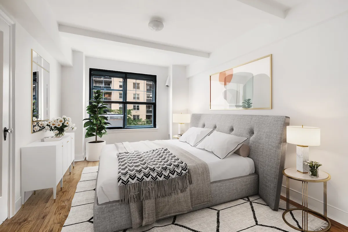 a bedroom with a large bed and a window