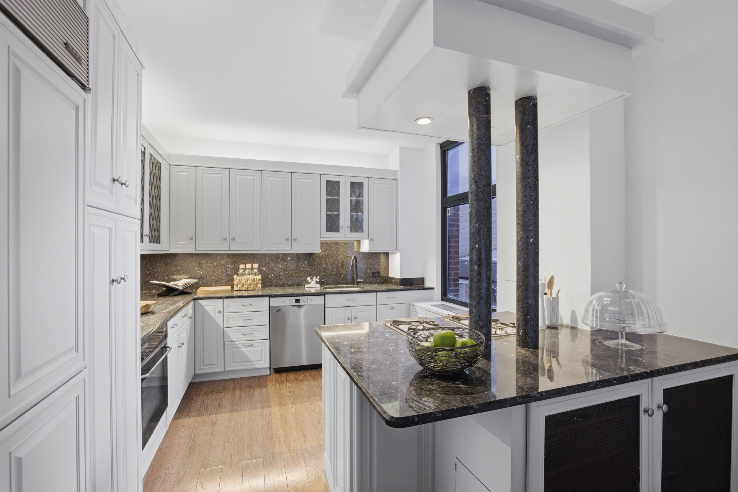 188 East 70th Street, Unit 3A Manhattan, NY 10021 - Photo 7 of 18 a kitchen with stainless steel appliances granite countertop refrigerator a sink and a stove