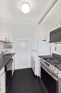 a kitchen with granite countertop a stove and a sink