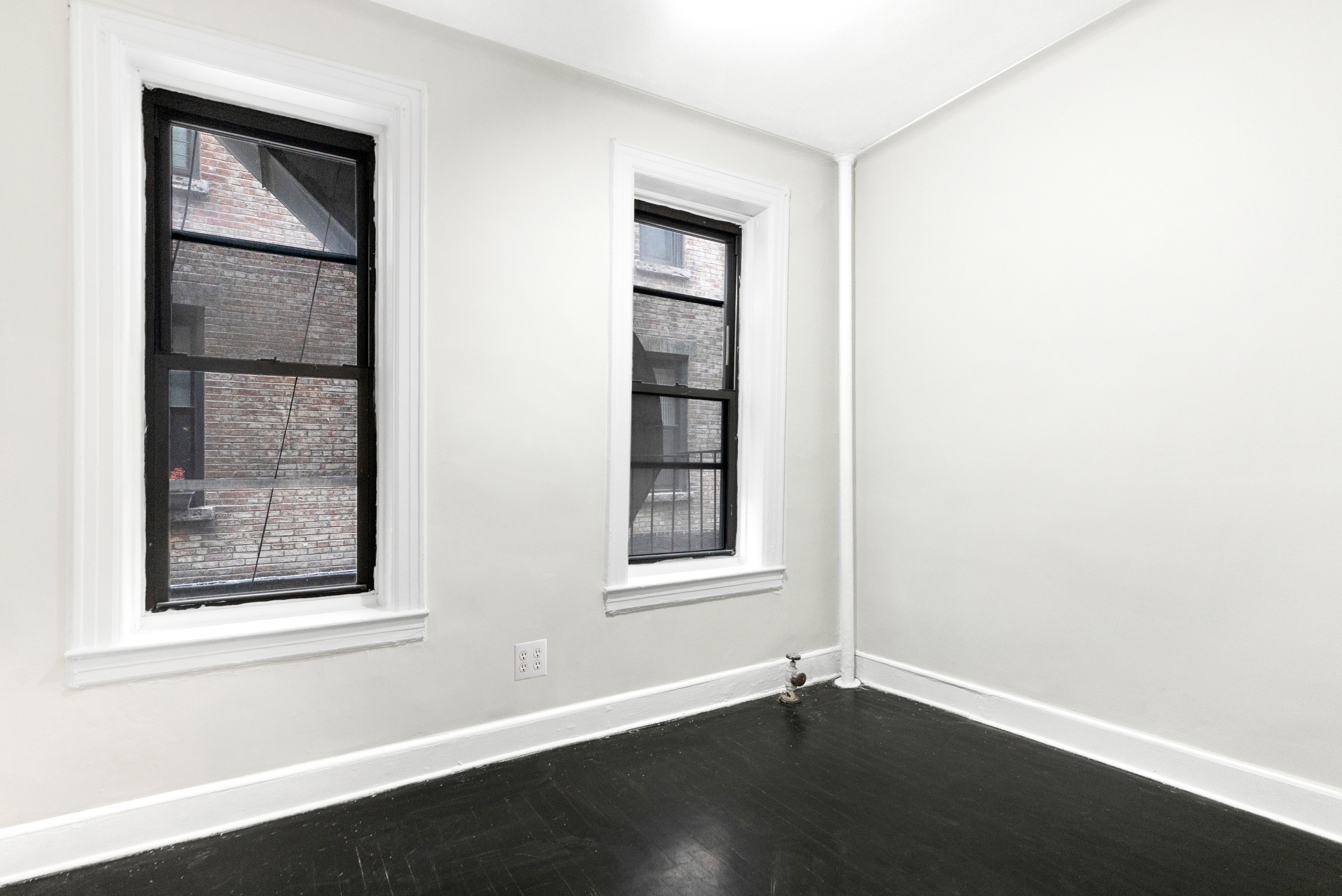1605 York Avenue, Unit 1A Manhattan, NY 10028 - Photo 5 of 8 an empty room with windows and closet