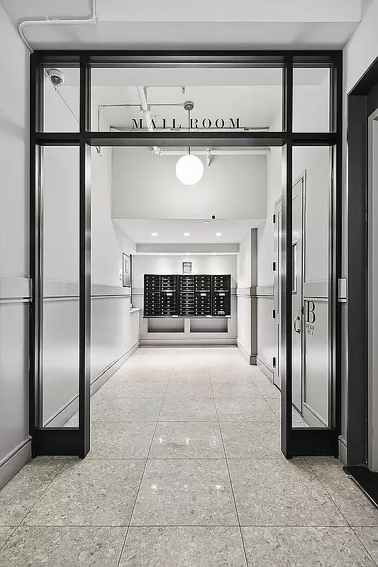 180 Bainbridge Street, Unit 112 Brooklyn, NY 11233 - Photo 18 of 30 a view of empty room with a fireplace and chandelier