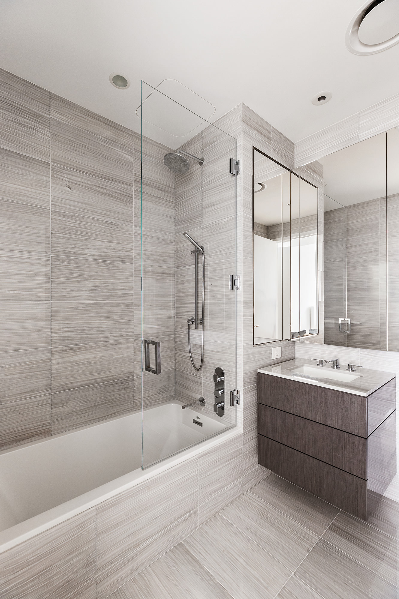 217 West 57th Street, Unit 57N Manhattan, NY 10019 - Photo 7 of 10 a bathroom with a bathtub and a sink