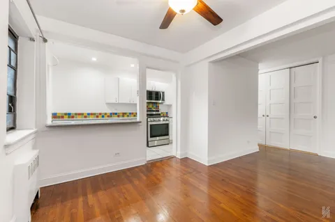a view of a kitchen with a sink and a refrigerator