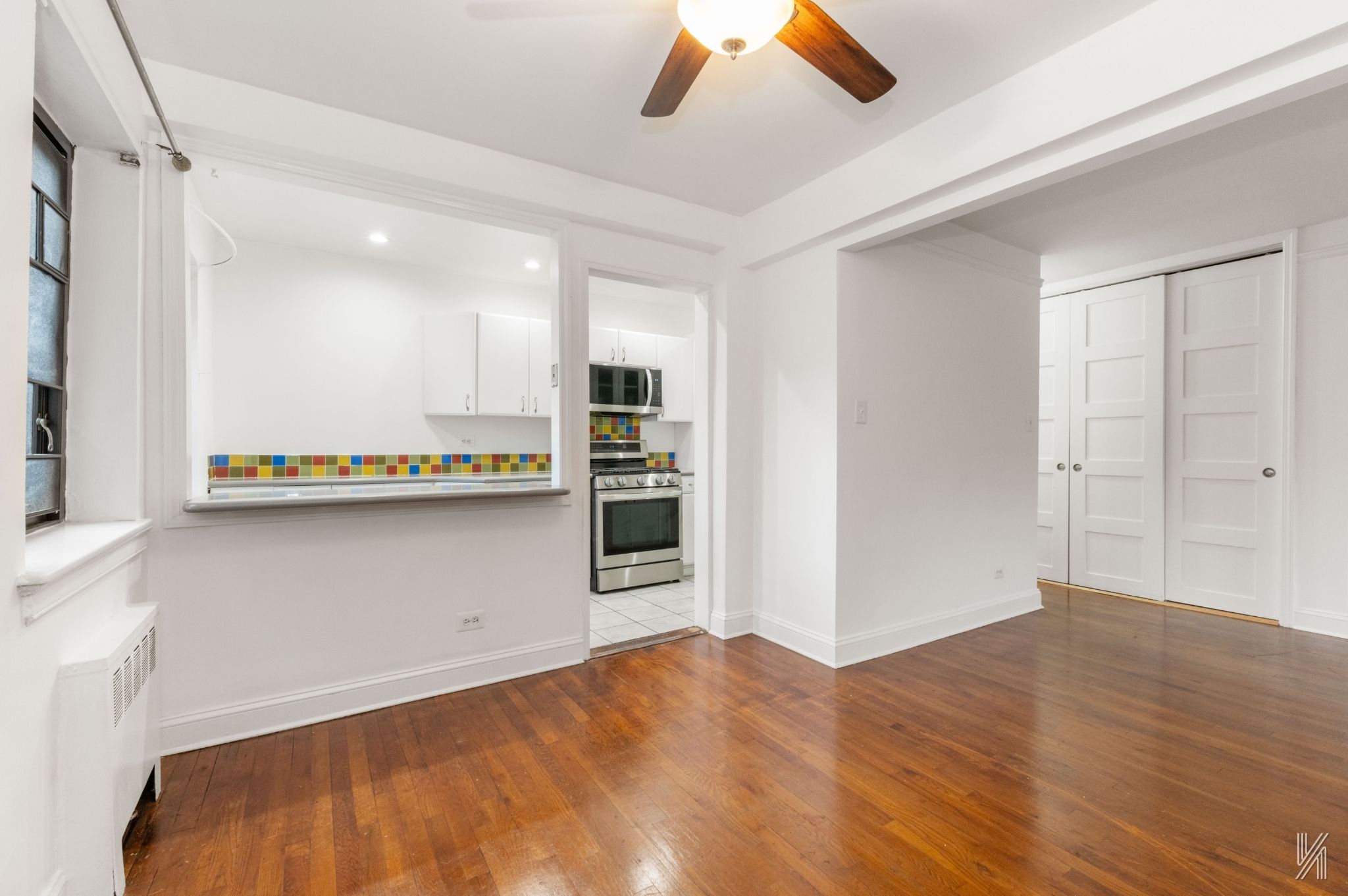 34-10 94th Street, Unit 6G Queens, NY 11372 - Photo 9 of 19 a view of a kitchen with a sink and a refrigerator