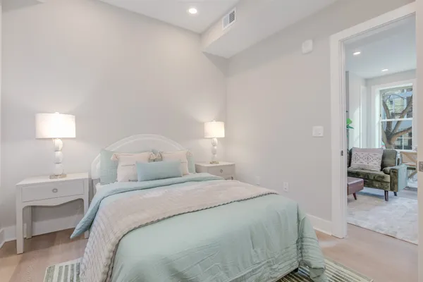 a bedroom with a bed and a lamp