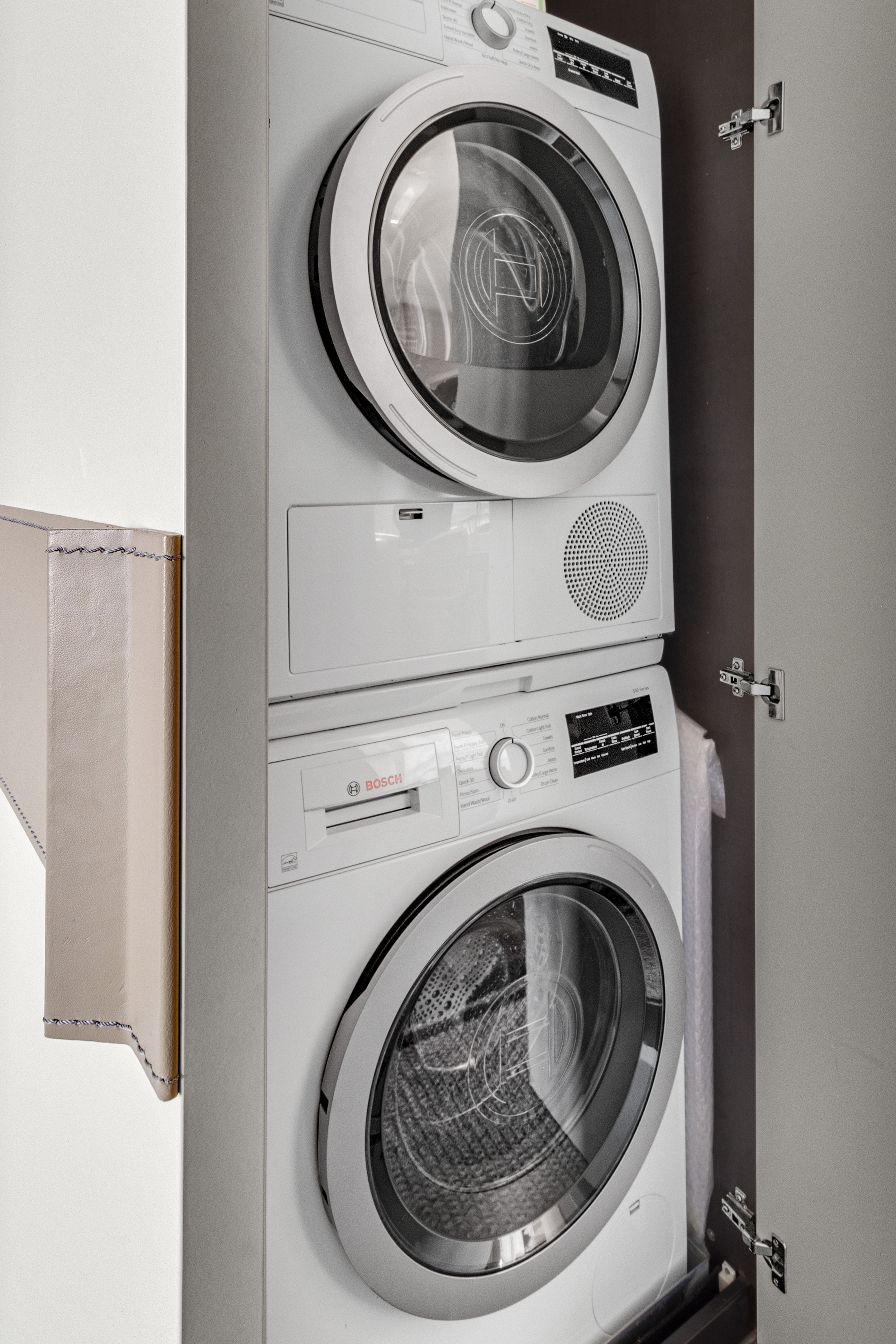 302 East 96th Street, Unit 1103 Manhattan, NY 10128 - Photo 10 of 22 a close up view of washer and dryer