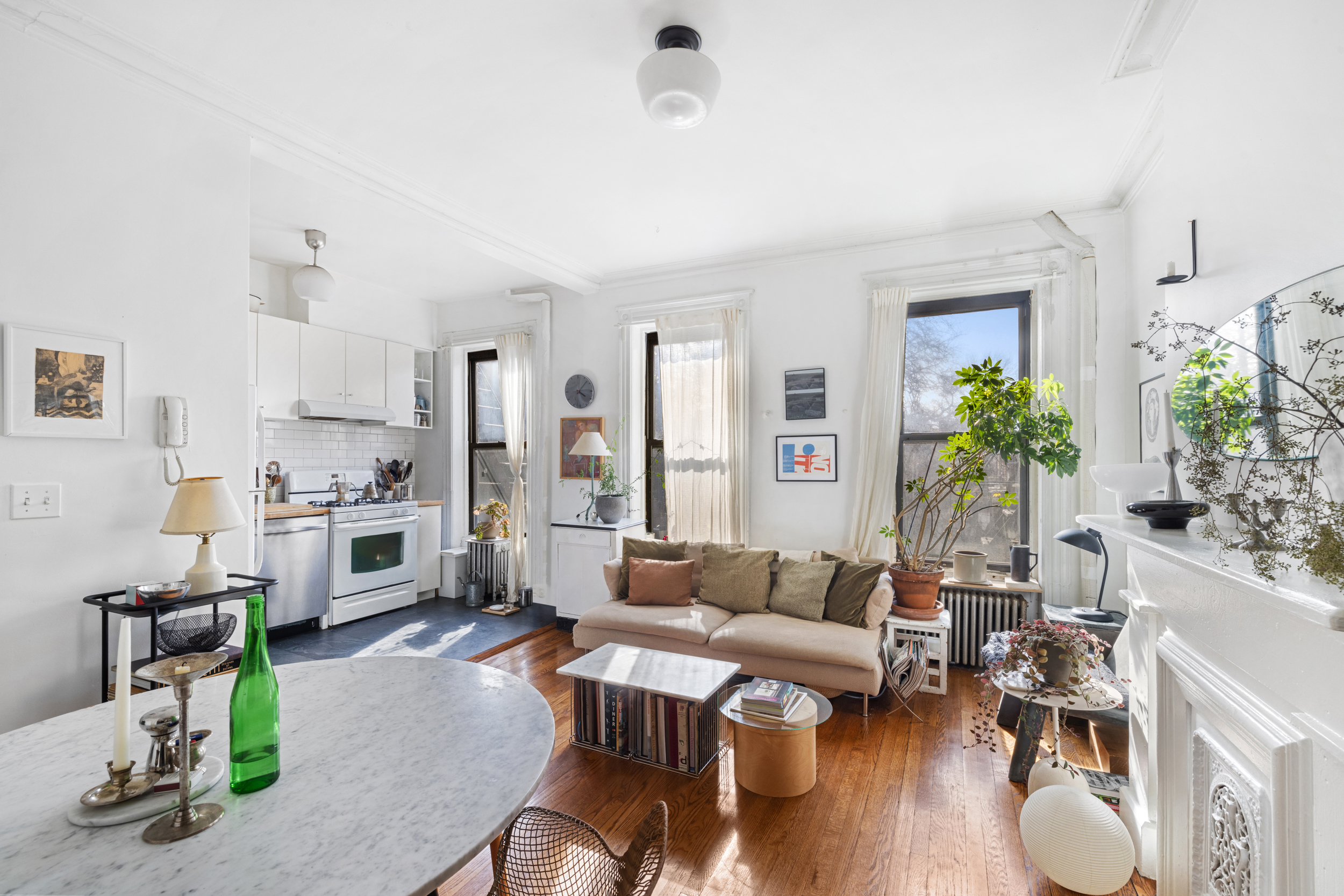 252 Stuyvesant Avenue Brooklyn, NY 11221 - Photo 19 of 26 a living room with furniture and a dining table with wooden floor