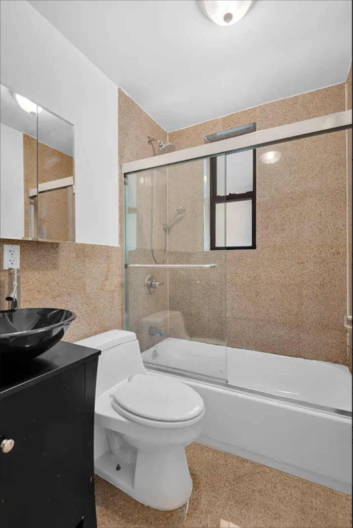 370 Columbus Avenue, Unit 2C Manhattan, NY 10024 - Photo 6 of 10 a bathroom with a toilet a sink and shower