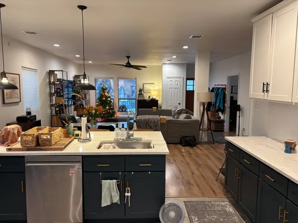 a kitchen with a sink appliances and cabinets