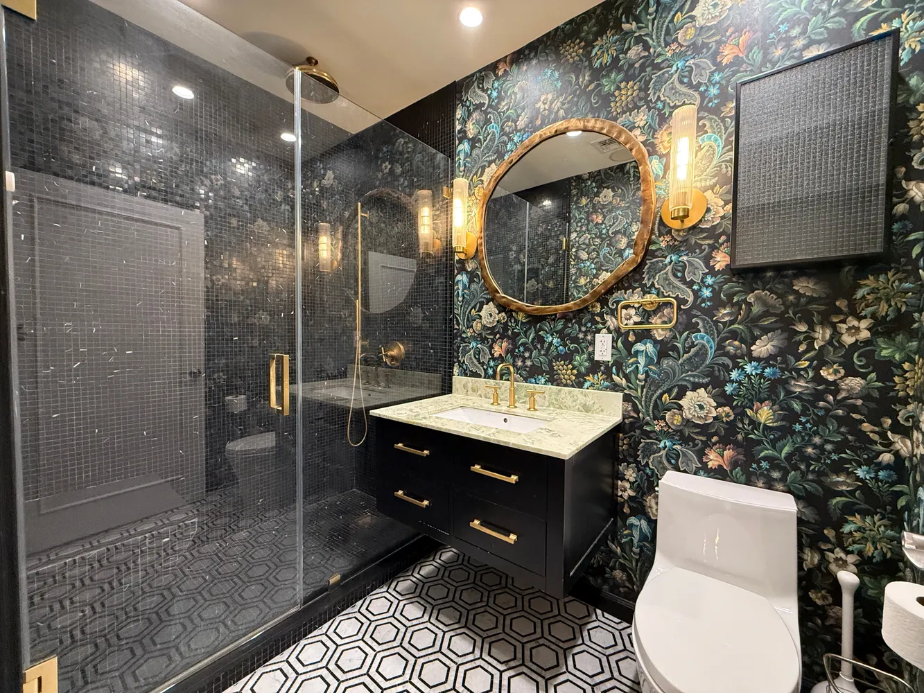 a bathroom with a toilet a sink and mirror