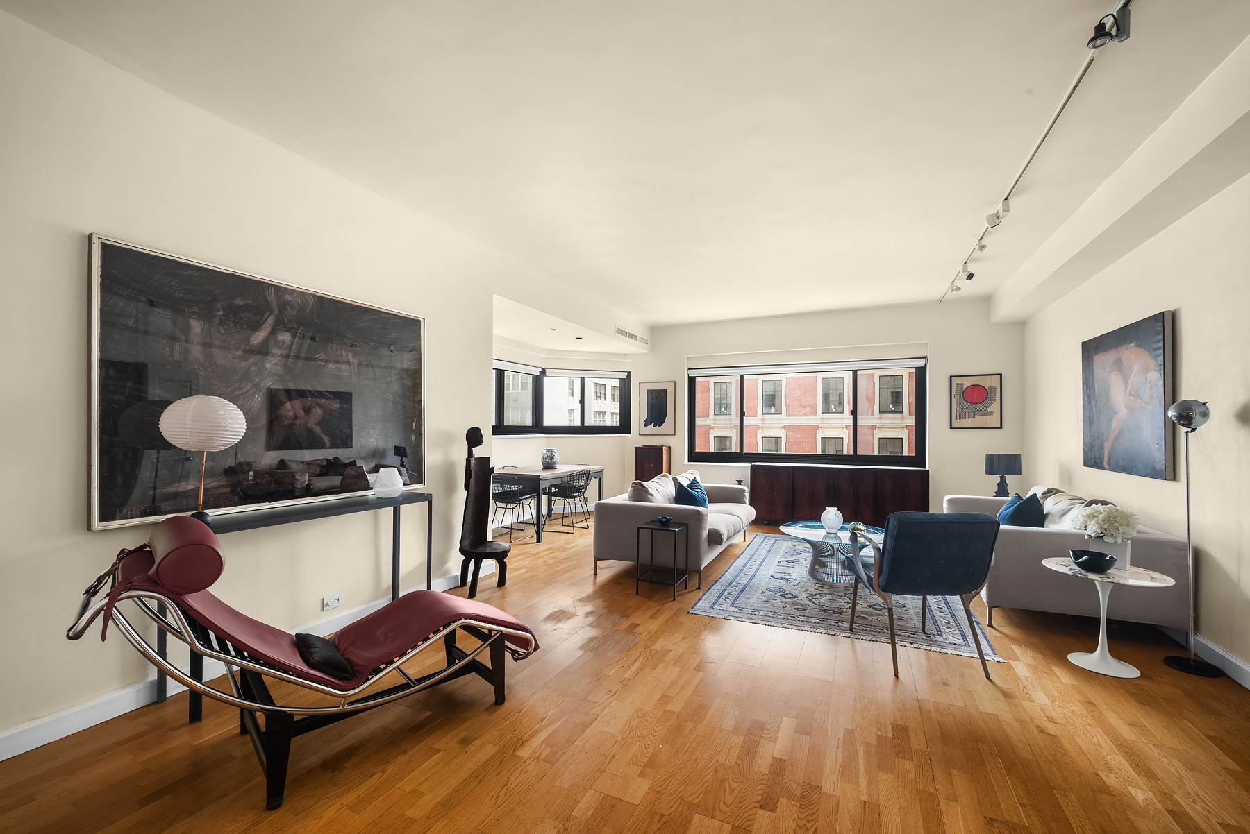 a living room with furniture a fireplace and wooden floor