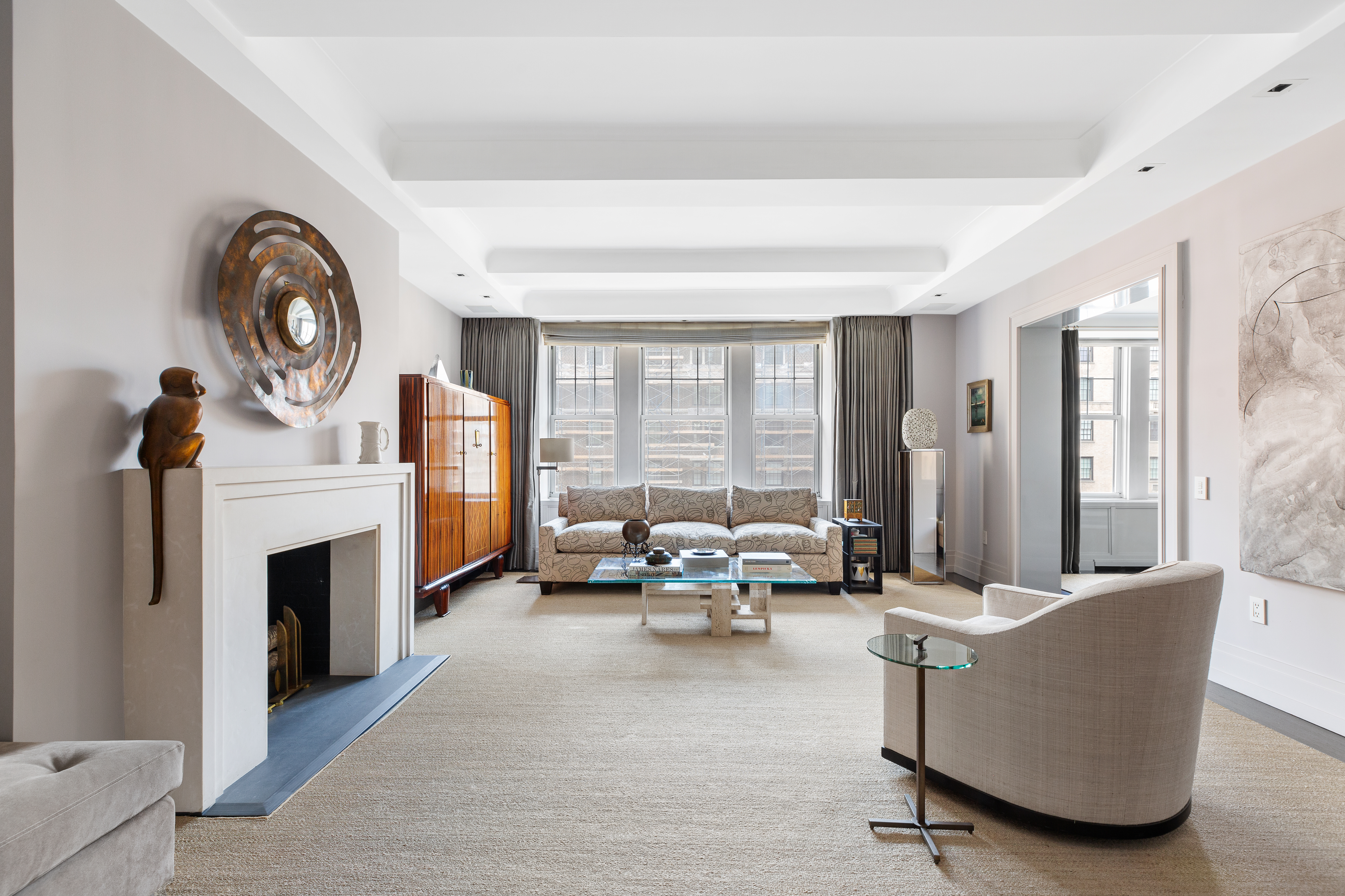 575 Park Avenue, Unit 902 Manhattan, NY 10065 - Photo 2 of 17 a living room with furniture and a fireplace