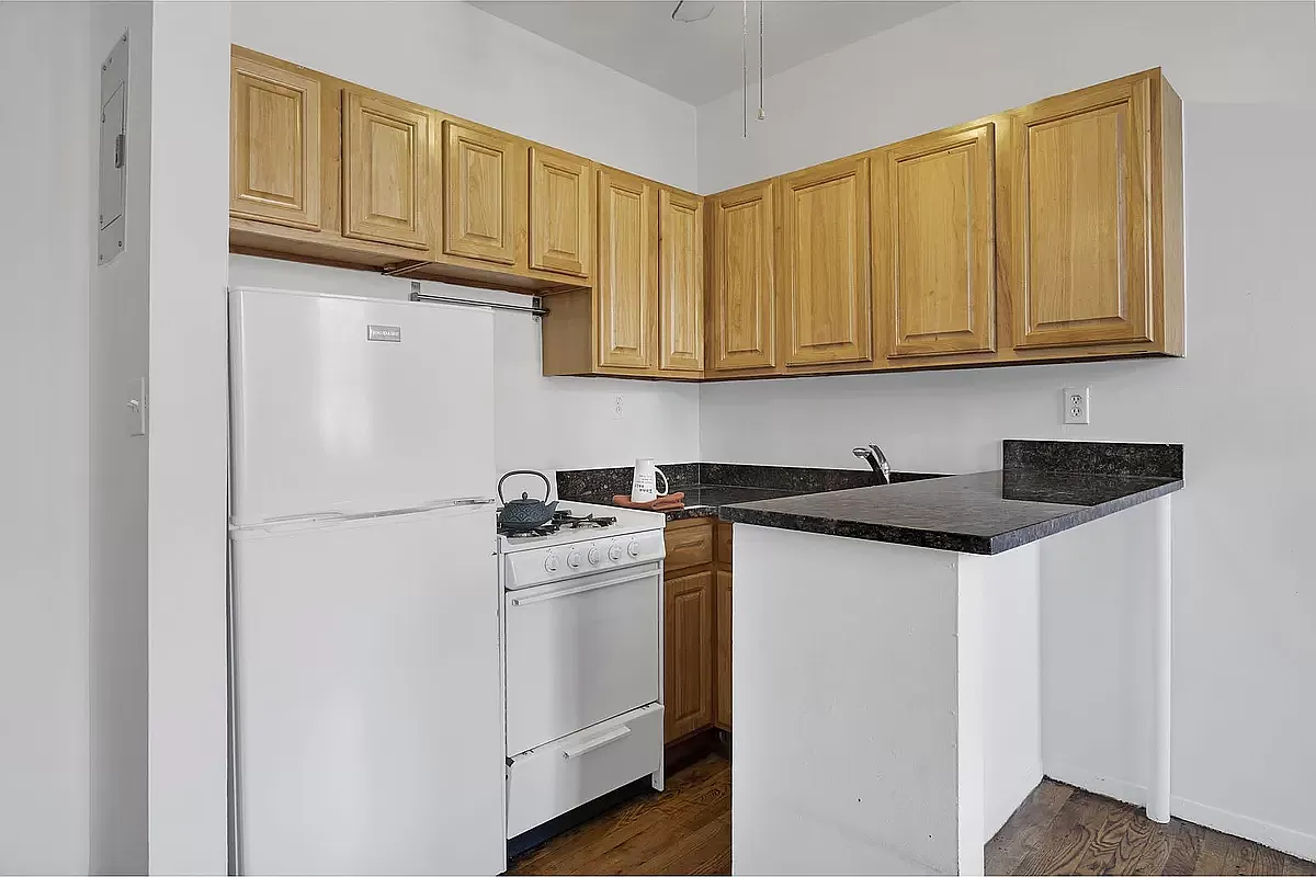 949 Columbus Avenue, Unit 1 Manhattan, NY 10025 - Photo 4 of 6 a kitchen with stainless steel appliances granite countertop a refrigerator a stove a sink and cabinets