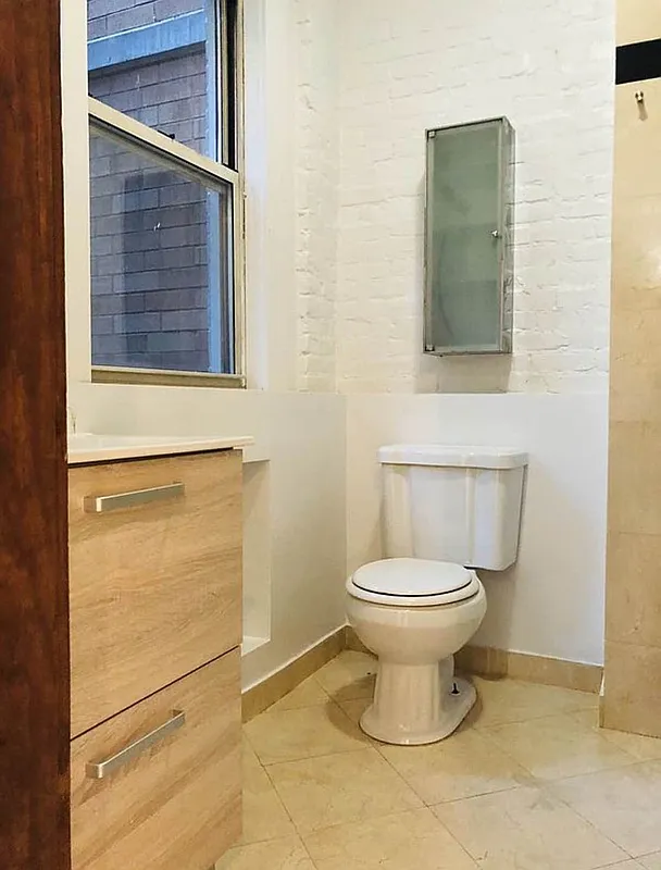112 West 15th Street, Unit 2 Manhattan, NY 10011 - Photo 7 of 13 a bathroom with a toilet and a sink