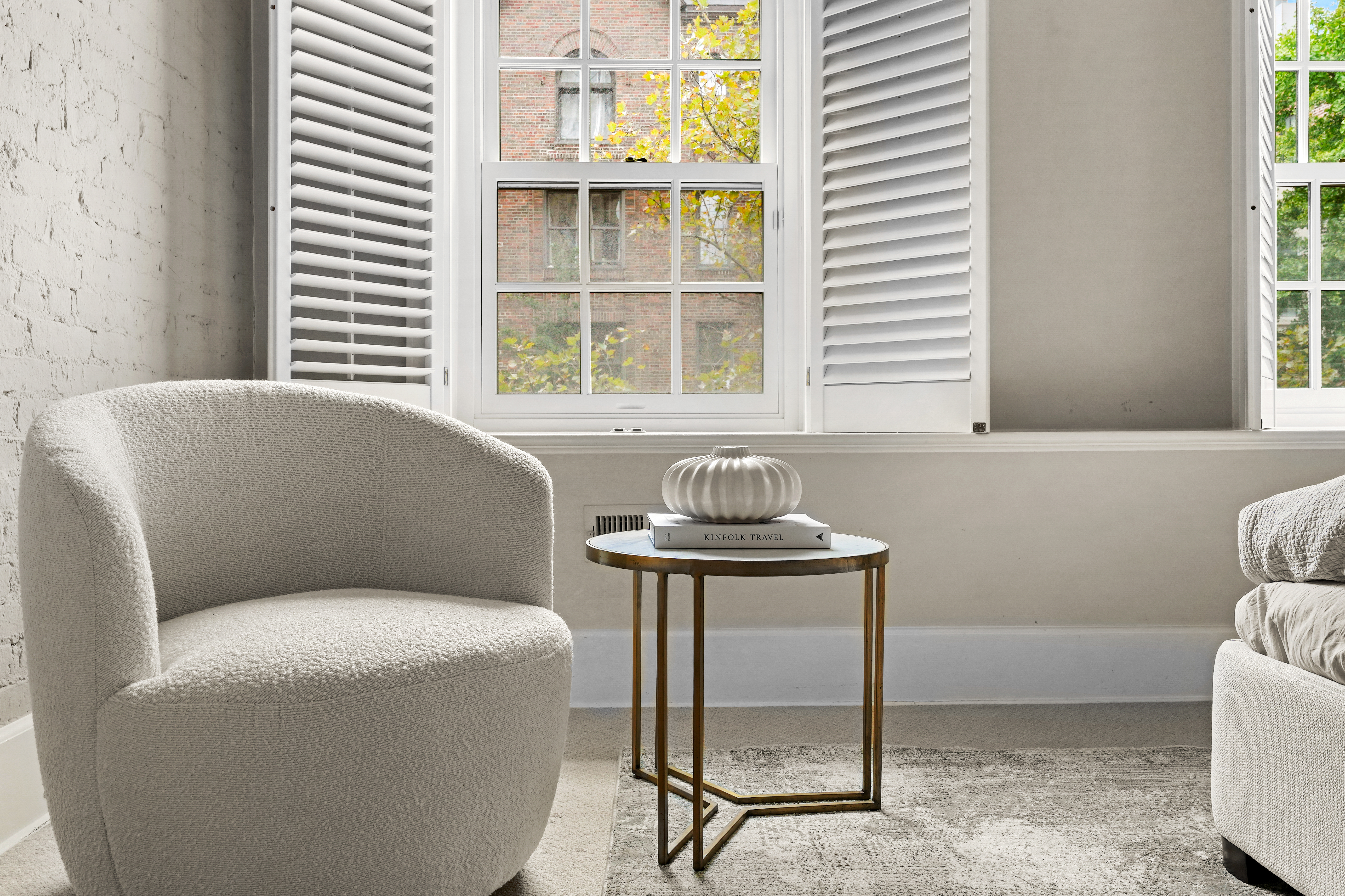 247 East 71st Street Manhattan, NY 10021 - Photo 20 of 31 a living room with furniture and a window