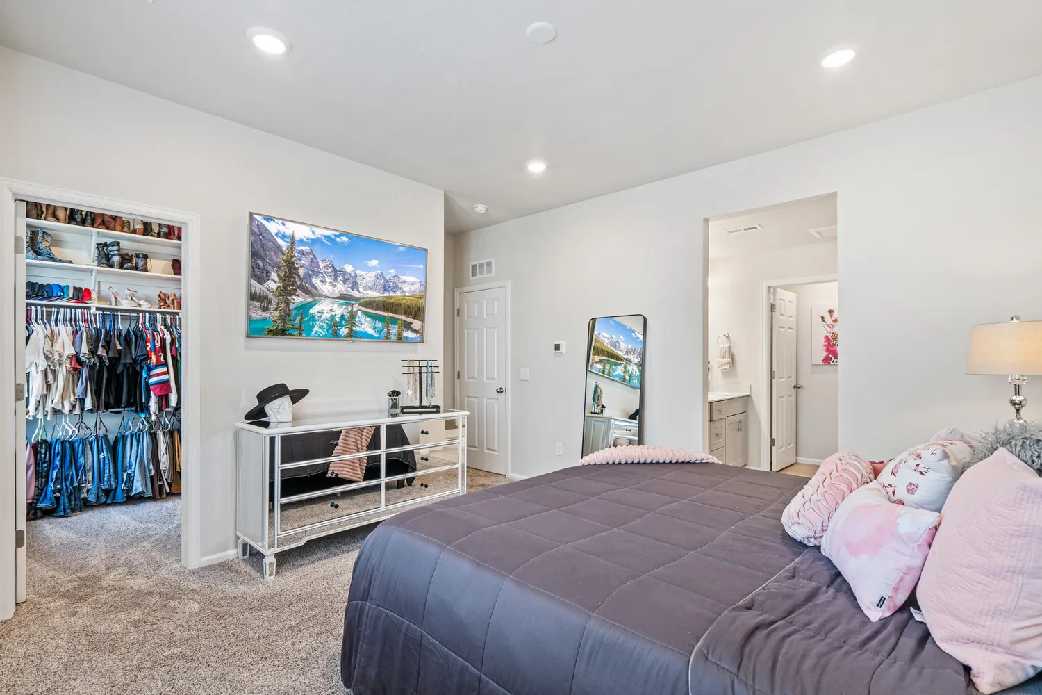a bedroom with bed and a flat screen tv