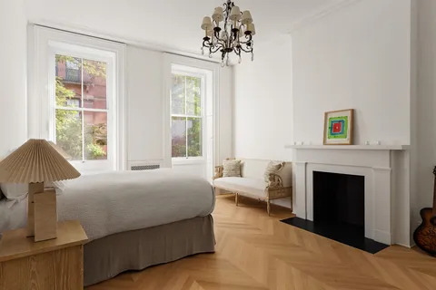 a bedroom with a bed and a fireplace