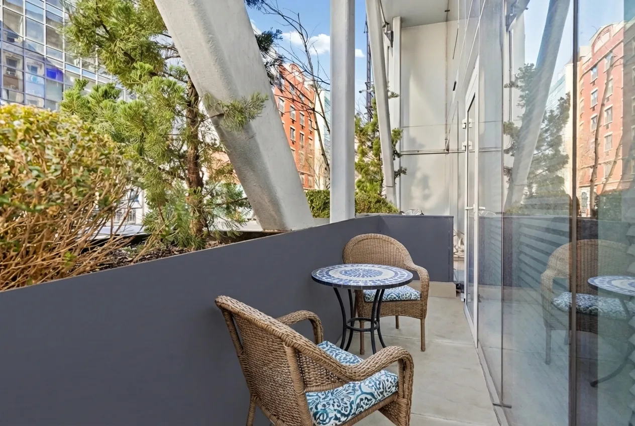 a view of a chairs and table in a balcony