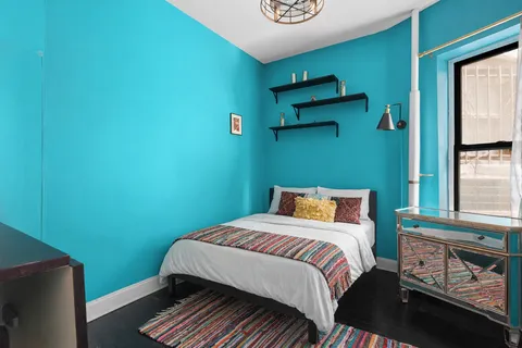 a bedroom with a bed and a window