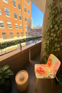 a view of a patio with table and chairs and potted plants