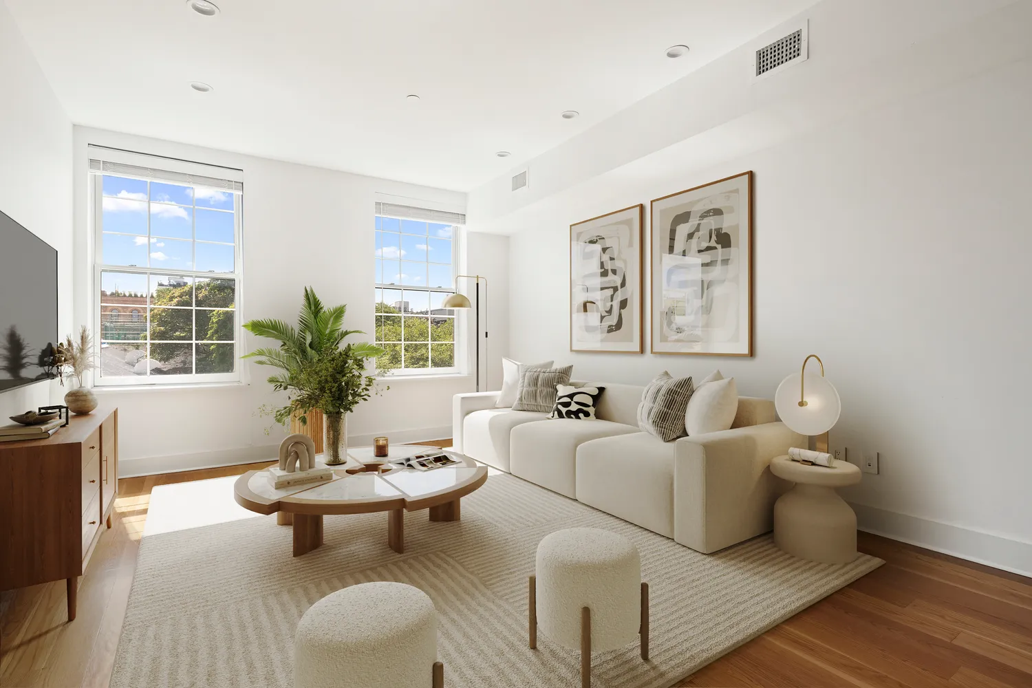 a living room with furniture and wooden floor