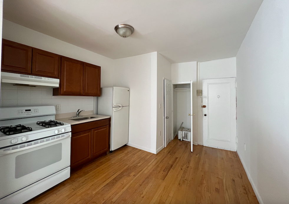 a kitchen with granite countertop wooden floors and stainless steel appliances