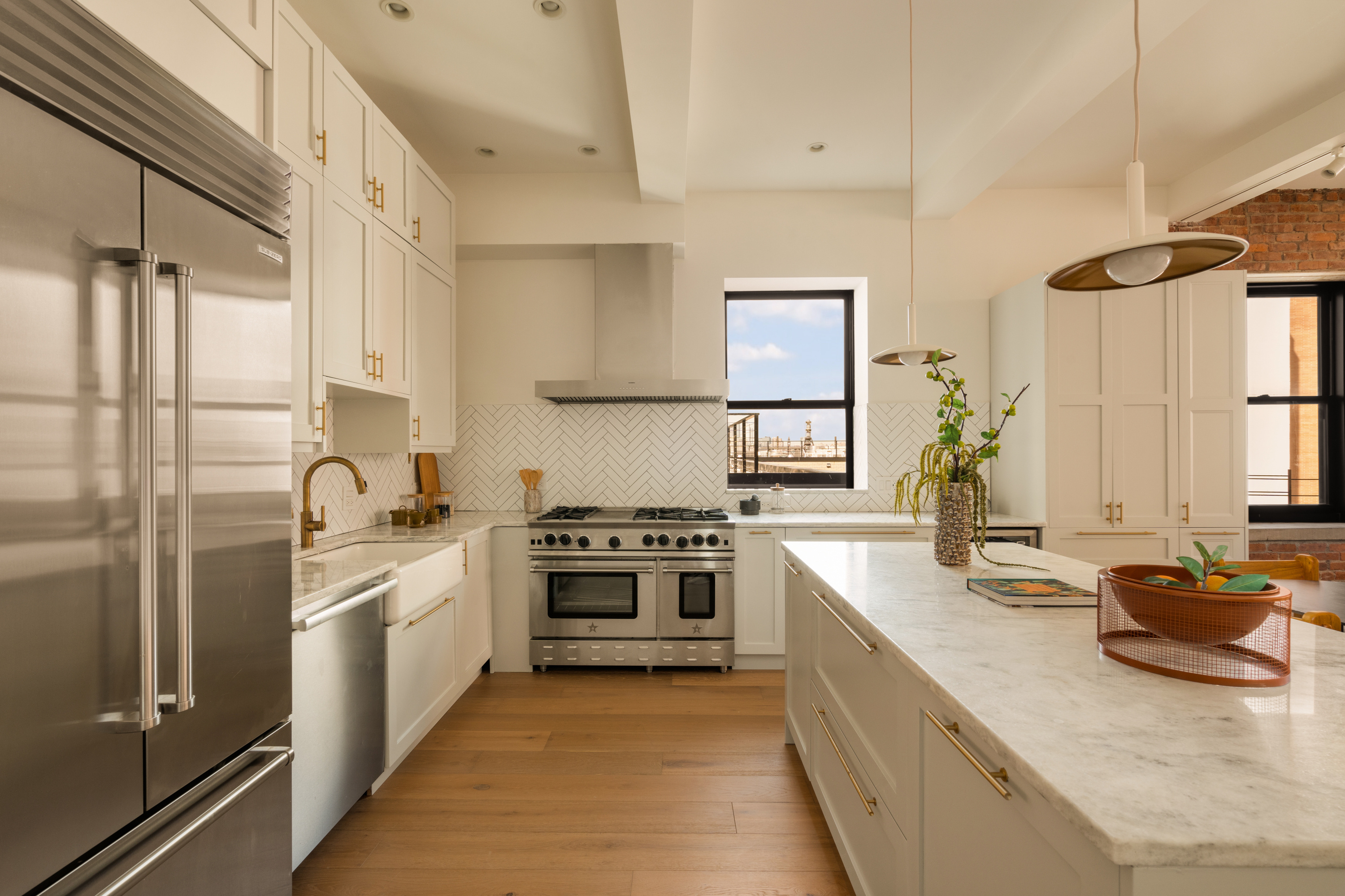165 Perry Street, Unit 5A Manhattan, NY 10014 - Photo 4 of 14 a kitchen with stainless steel appliances granite countertop a stove and a sink