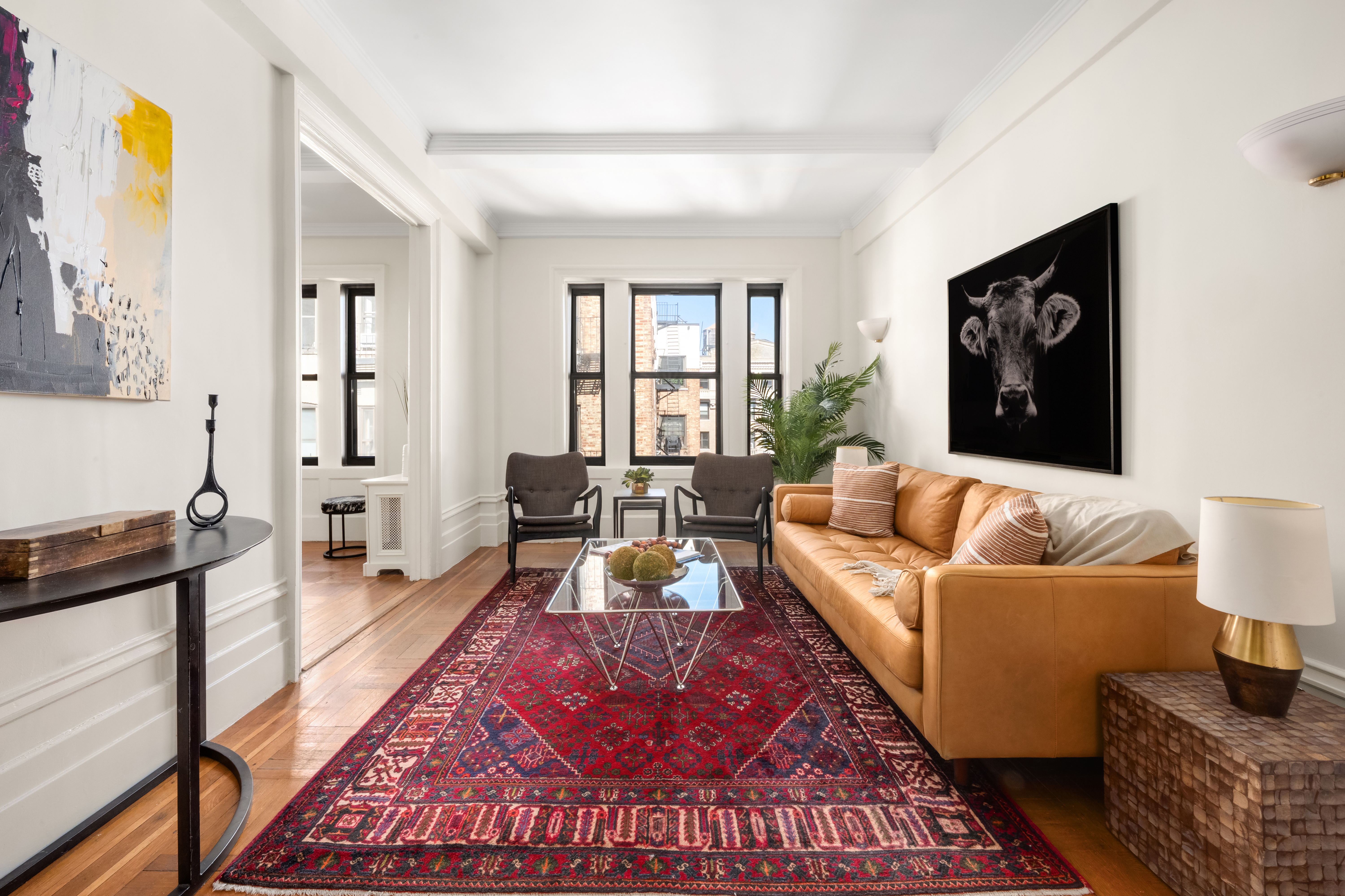 a living room with furniture rug and wooden floor