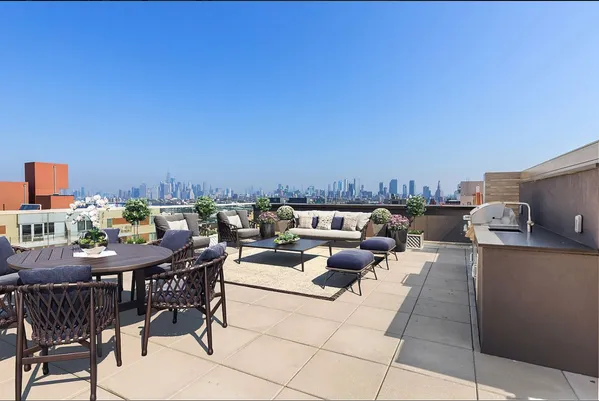a terrace with outdoor seating and city view