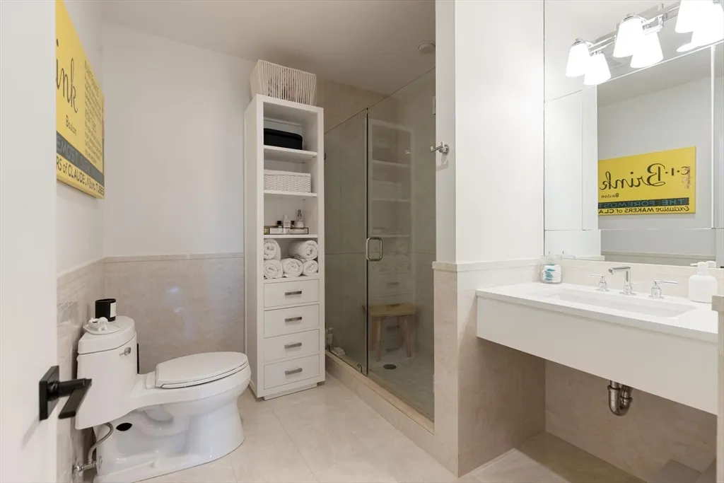 a bathroom with a toilet sink and shower