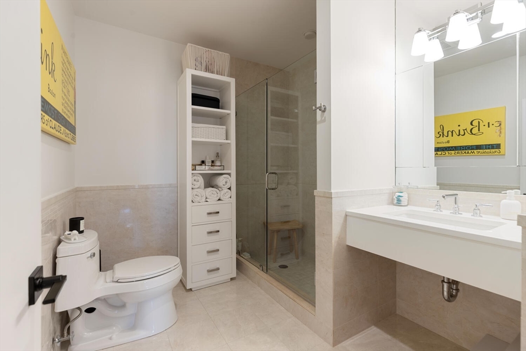 35 Channel Center Street, Unit 402 Boston, MA 02210 - Photo 23 of 35 a bathroom with a toilet sink and shower