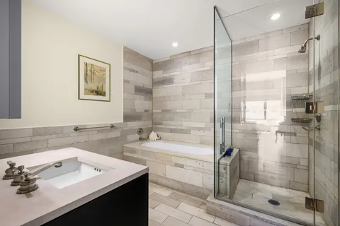 a bathroom with a shower sink and mirror